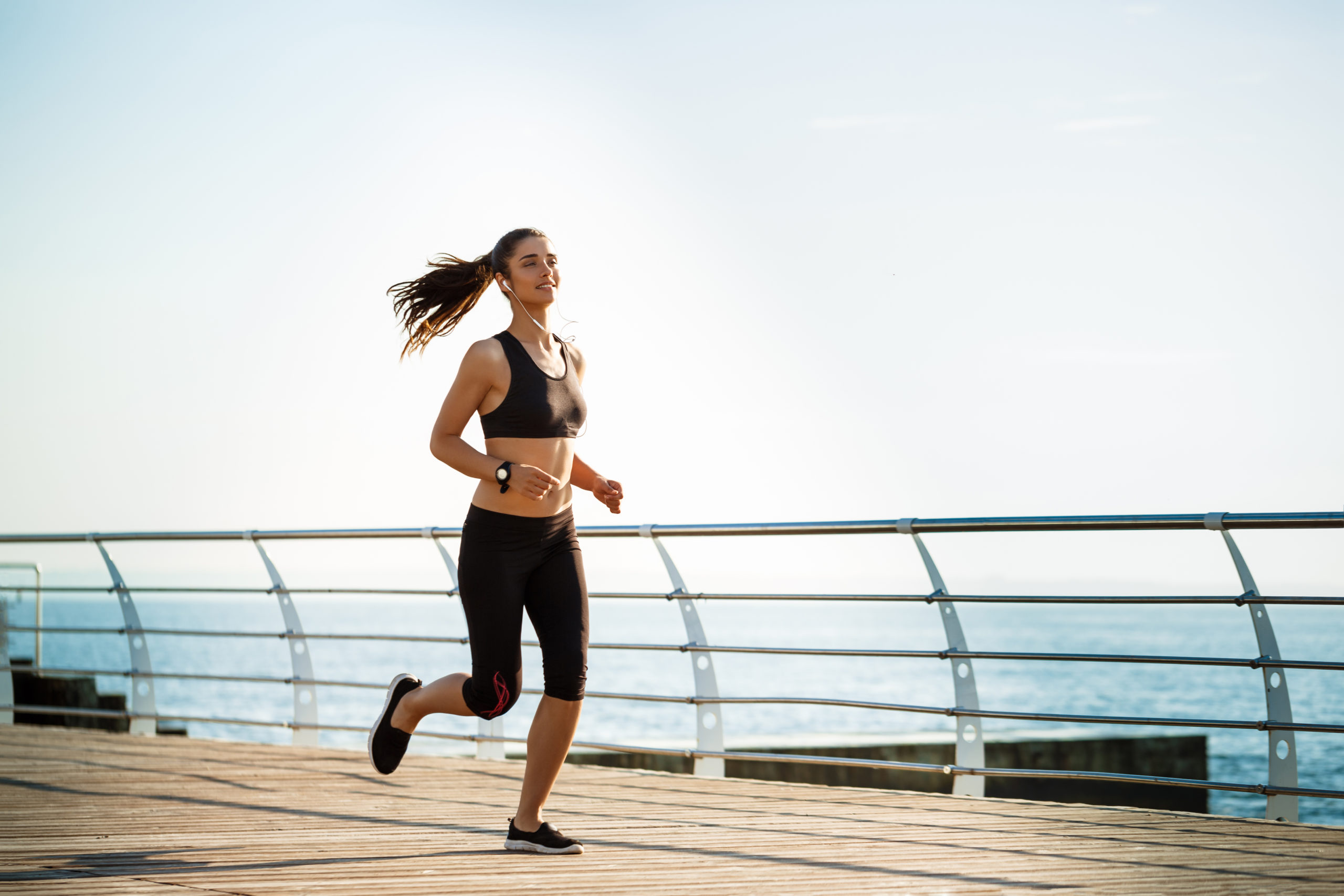 picture young attractive fitness woman running with sea wall scaled